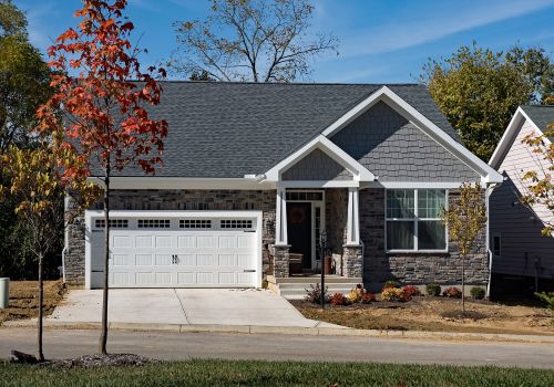 Newly-Built-Upscale-Stone-Home-in-Fall-with-White-Garage-Door